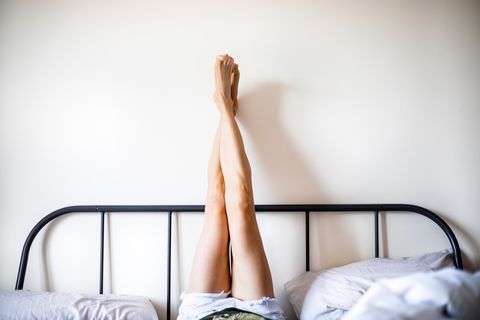 woman-with-legs-raised-wearing-white-shorts-lying-royalty-free-image-1655700387.jpg